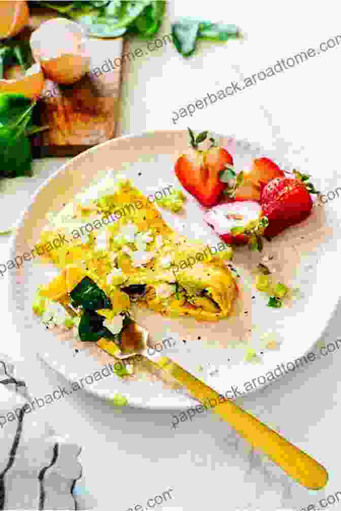 A Colorful Omelet Filled With Spinach, Feta, And Tomatoes On A Plate With Avocado On The Side Quick And Easy Paleo Breakfast Recipes: Delicious Breakfast Recipes To Eat On The Paleo Diet If You Want To Lose Weight Be Healthy And Make Your Mornings (The Essential Kitchen 14)