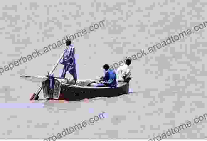 A Traditional Wooden Boat Gliding Along The Broad Expanse Of The Indus River, Fishermen Casting Their Nets Into The Shimmering Waters My Sindh: A Journey To The Beloved Homeland